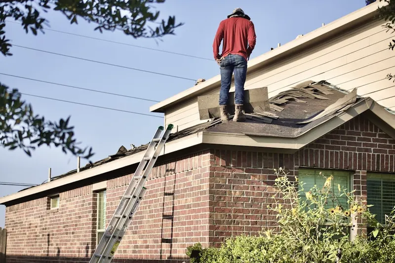 Professional roofer working on a residential roof in Salida